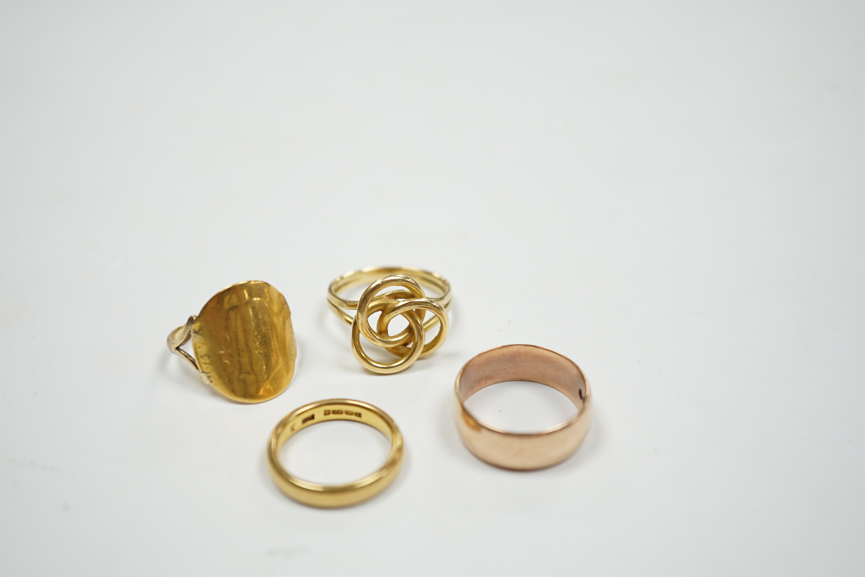 A 1930's 22ct gold wedding band, 5.9 grams, a 9ct gold wedding band, 5.1 grams and two other yellow metal rings, 10.1 grams.